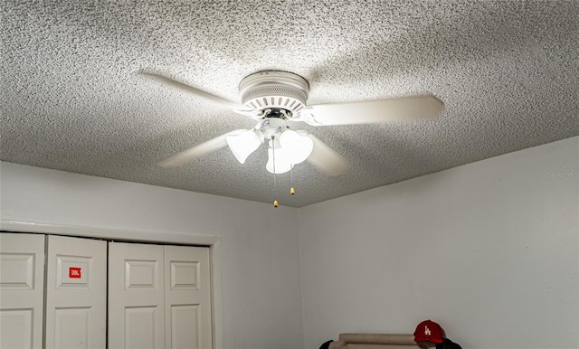 room details with a textured ceiling and ceiling fan