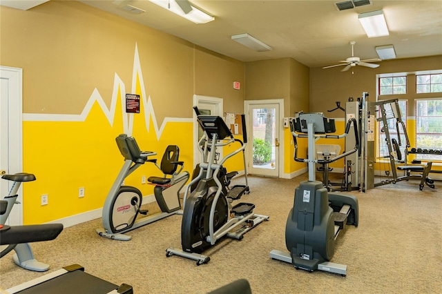 gym featuring carpet floors, ceiling fan, and a healthy amount of sunlight