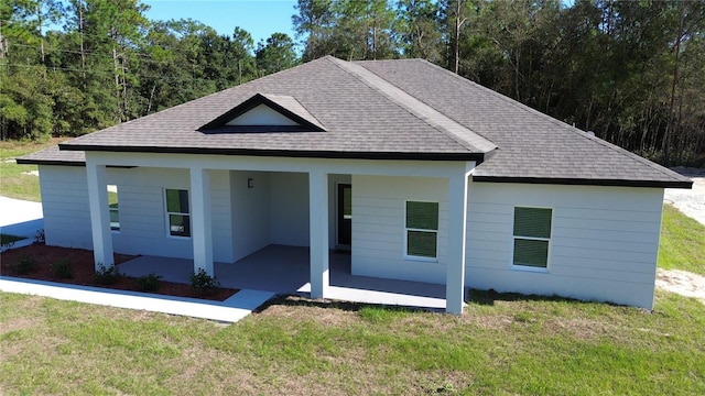 view of front of house with a front lawn and a patio area