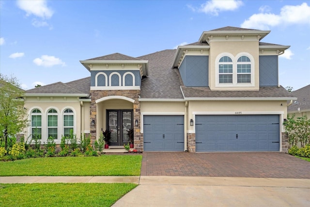 view of front of property featuring a garage and a front lawn