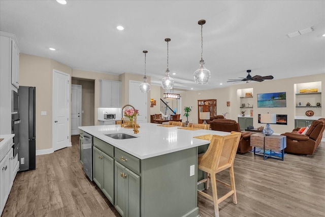 kitchen featuring white cabinets, light wood-type flooring, and sink