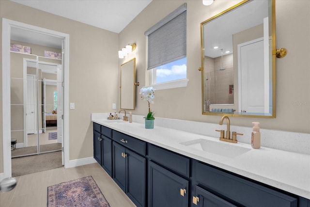 bathroom with tile patterned floors, a tile shower, and vanity