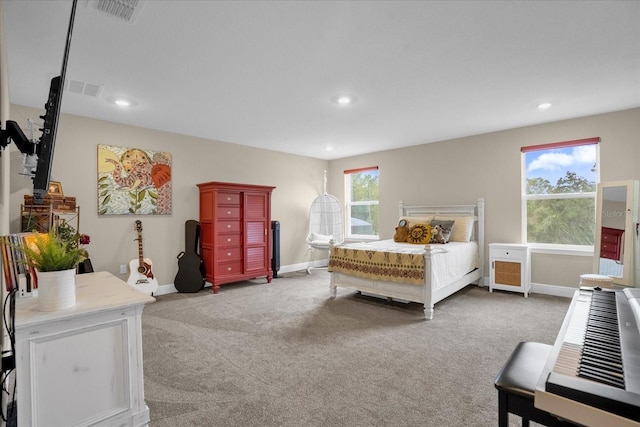 bedroom with light colored carpet and multiple windows