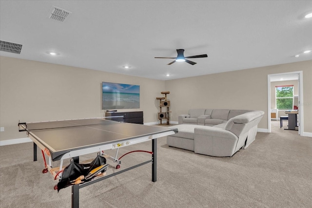 recreation room with ceiling fan and light carpet