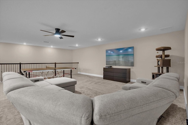 carpeted living room with ceiling fan