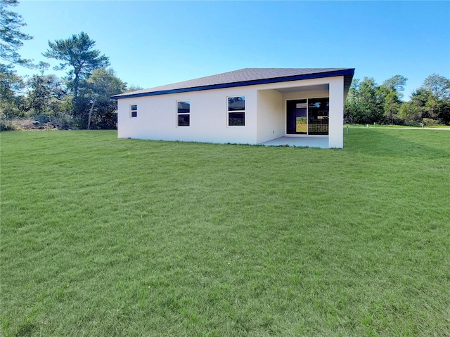 rear view of property with a lawn