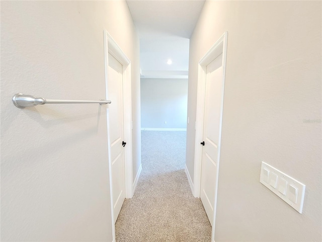 hallway with light colored carpet