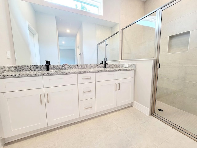 bathroom with vanity, walk in shower, and tile patterned flooring