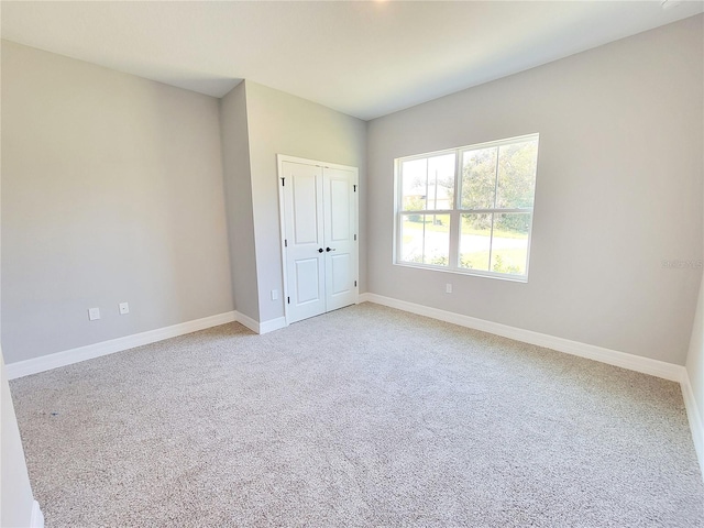 unfurnished bedroom with a closet and carpet floors