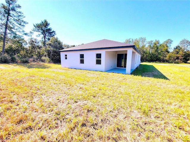 rear view of property featuring a yard