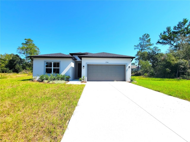 view of front facade with a front lawn and a garage