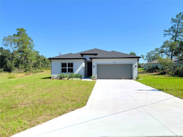 view of front of property featuring a front lawn and a garage