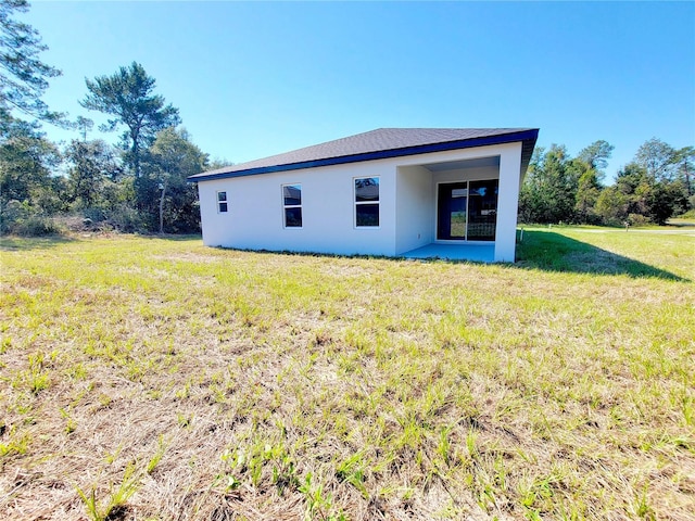 rear view of property with a yard