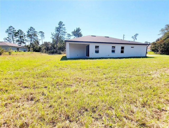 rear view of house with a yard