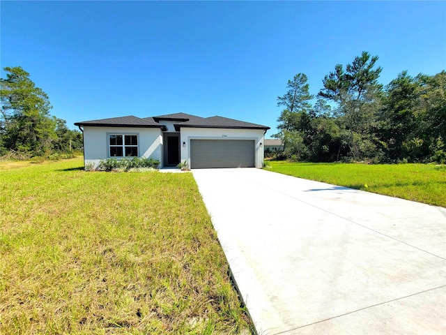 view of front of home featuring a front lawn and a garage