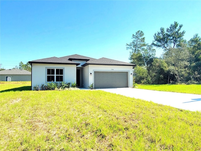 view of front of home with a front lawn and a garage