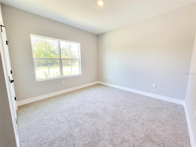 unfurnished room featuring carpet flooring