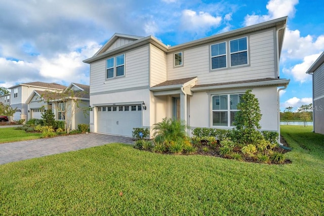 view of front of house featuring a garage and a front lawn