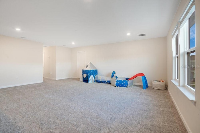 rec room with light colored carpet and a wealth of natural light