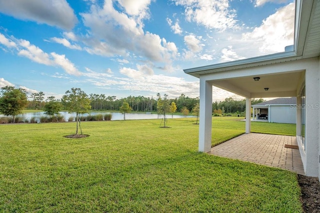 view of yard featuring a water view and a patio area