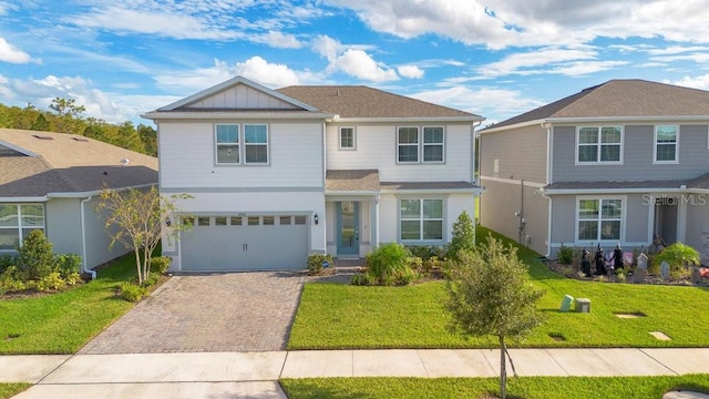 front of property with a front yard and a garage