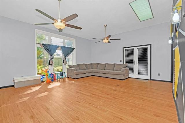 unfurnished living room with light wood-type flooring and ceiling fan