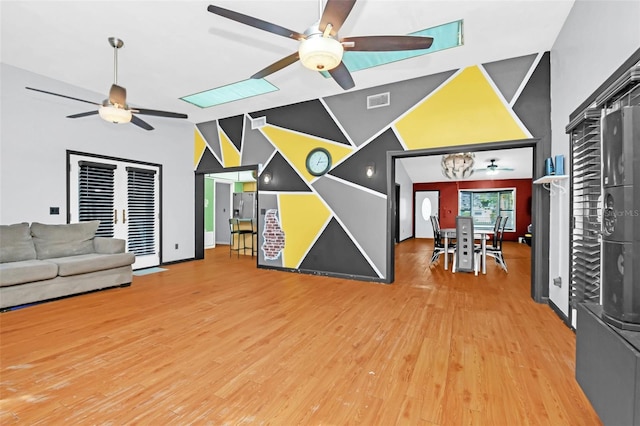 living room with wood-type flooring and lofted ceiling