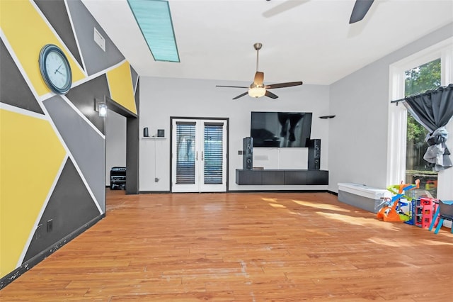 unfurnished living room with hardwood / wood-style flooring and ceiling fan