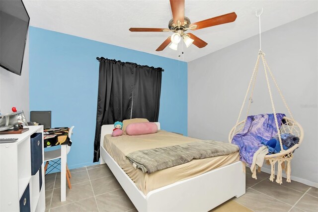 bedroom featuring light tile patterned flooring and ceiling fan