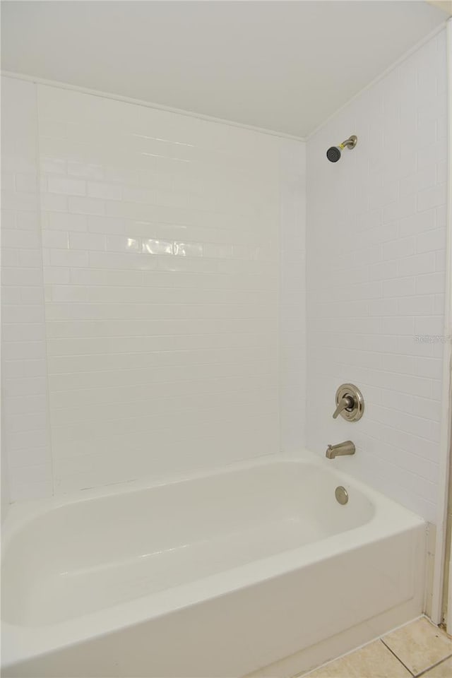 bathroom with tile patterned flooring and tiled shower / bath combo