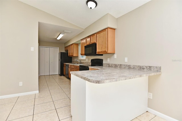 kitchen featuring light tile patterned flooring, sink, kitchen peninsula, black appliances, and vaulted ceiling