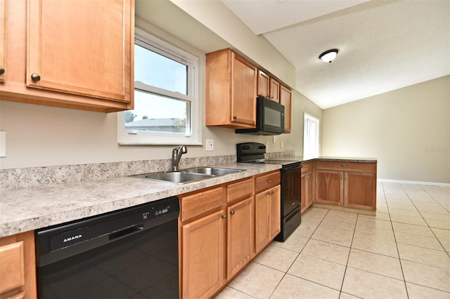 kitchen with light tile patterned floors, sink, a textured ceiling, black appliances, and vaulted ceiling