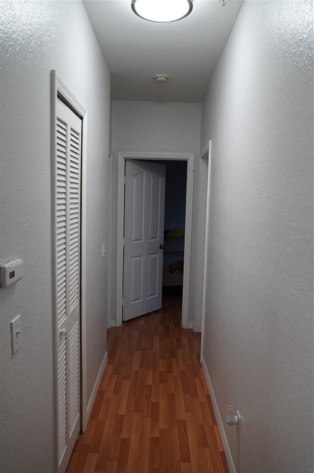 corridor featuring dark hardwood / wood-style floors