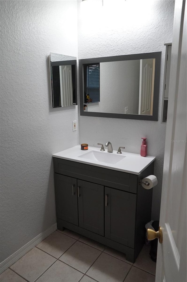 bathroom with tile patterned floors and vanity