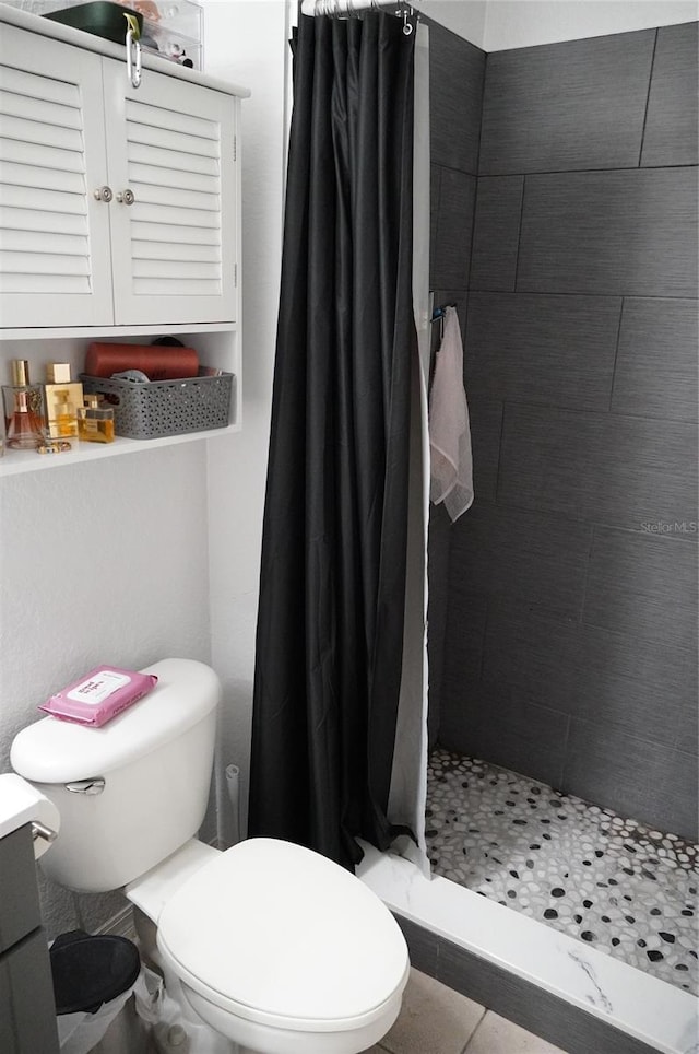 bathroom featuring toilet, tile patterned floors, a shower with curtain, and vanity