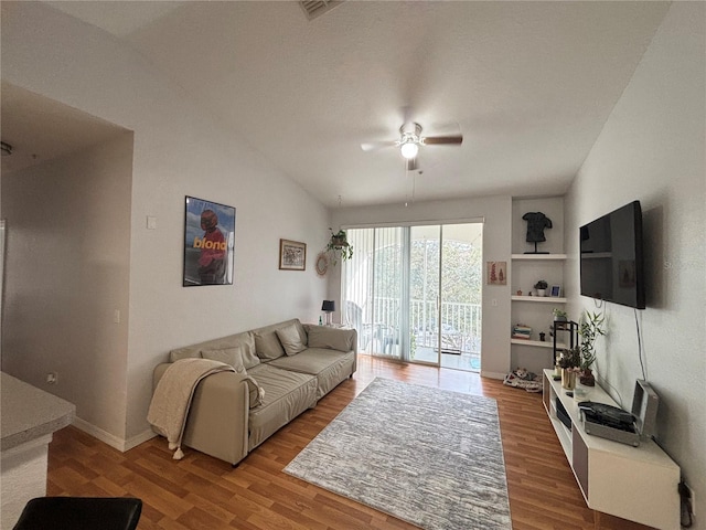 living area with wood finished floors, visible vents, baseboards, lofted ceiling, and ceiling fan