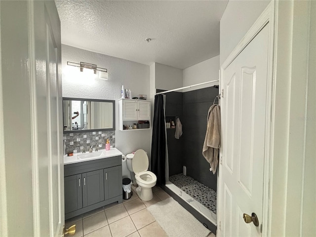 bathroom featuring toilet, tile patterned flooring, a shower with curtain, and vanity