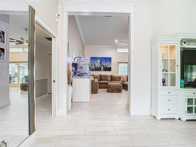 corridor featuring ornamental molding and a high ceiling