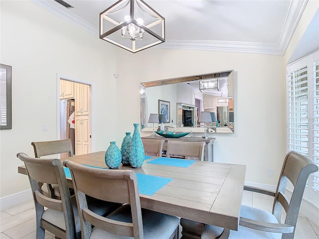 dining area with crown molding, a notable chandelier, and lofted ceiling