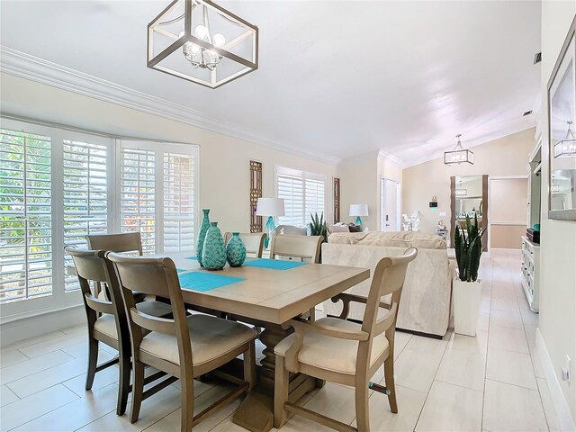 dining room with light tile patterned floors, crown molding, lofted ceiling, and a wealth of natural light