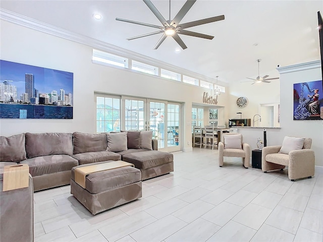 living room featuring crown molding, ceiling fan, a high ceiling, and light tile patterned floors