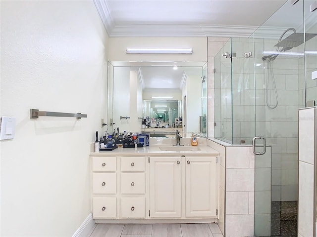 bathroom with vanity, an enclosed shower, and ornamental molding