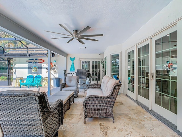 view of patio with french doors, ceiling fan, glass enclosure, and an outdoor hangout area