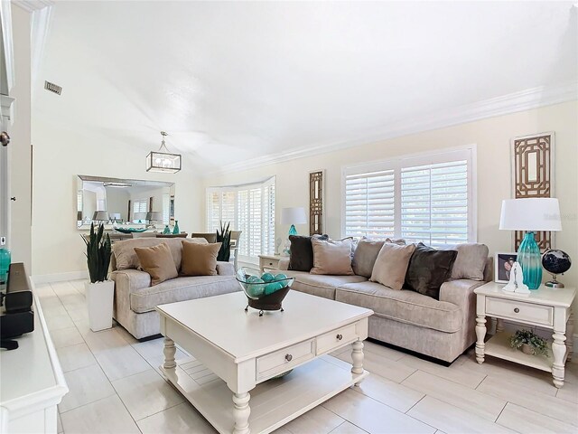 living room featuring ornamental molding and a chandelier