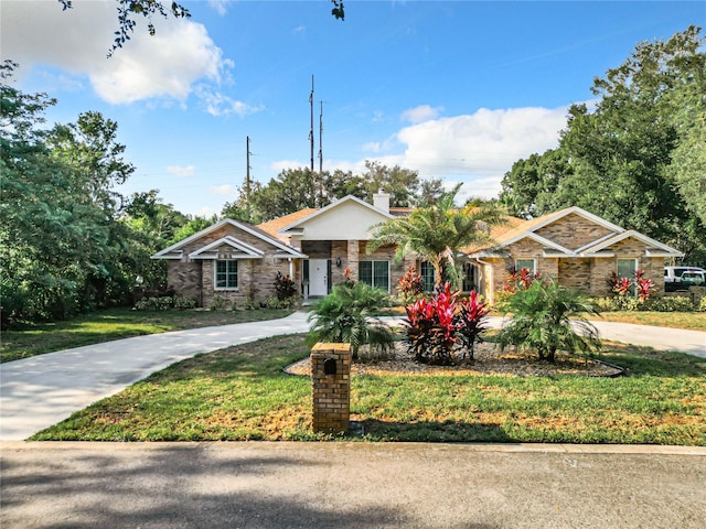 single story home featuring a front lawn