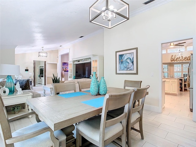 dining space featuring crown molding and a chandelier