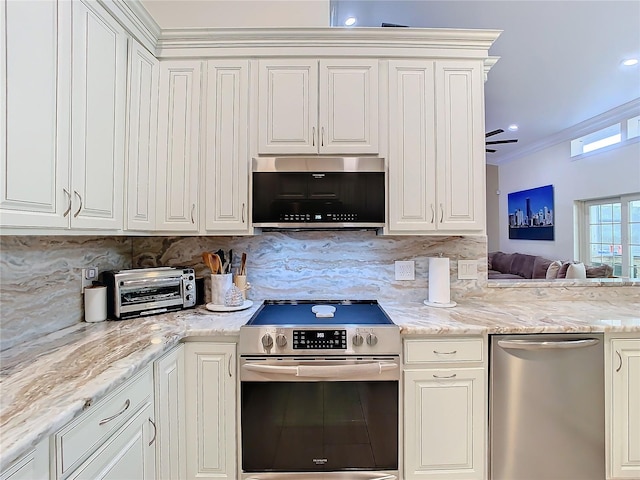 kitchen featuring appliances with stainless steel finishes, decorative backsplash, ornamental molding, and white cabinetry