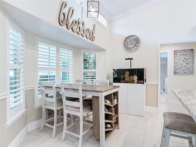 dining space featuring ornamental molding and light tile patterned flooring