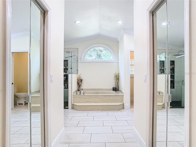 bathroom featuring toilet, tile patterned flooring, separate shower and tub, ornamental molding, and vaulted ceiling