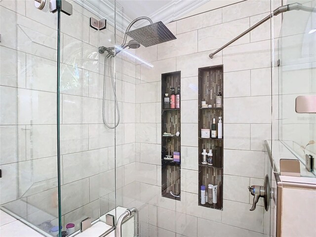 bathroom with a shower with door, ornamental molding, and vanity